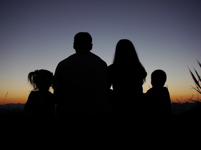 A couple sharing a quiet moment in silhouette